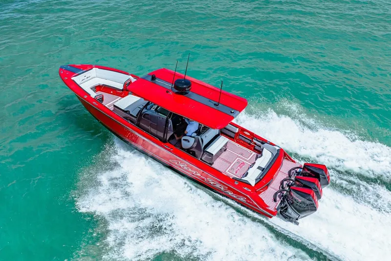  Yacht Photos Pics Red 2022 Nor-Tech 390 SS speedboat cruising on turquoise water.