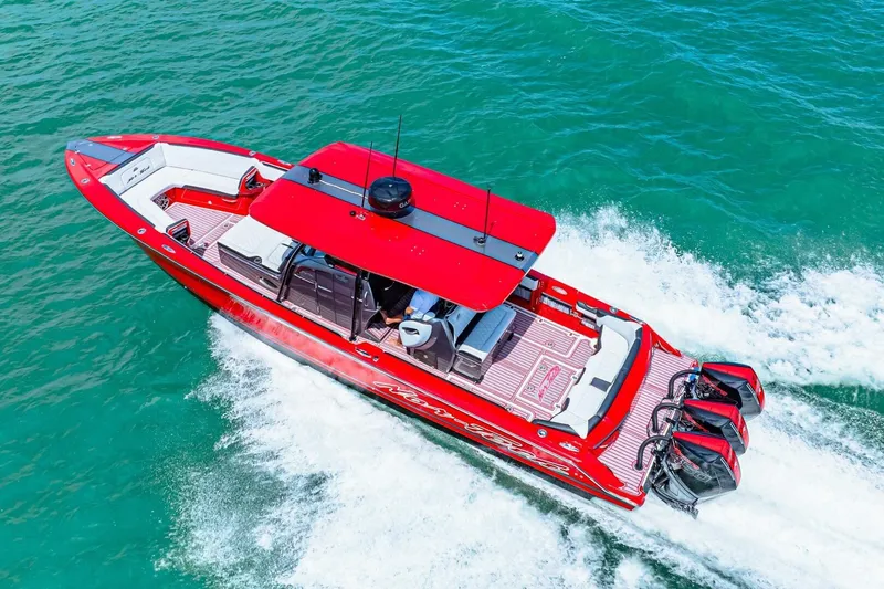 Yacht Photos Pics Red 2022 Nor-Tech 390 SS boat cruising on turquoise water, showcasing sleek design and powerful engines.