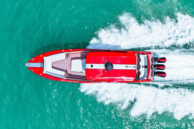  Yacht Photos Pics Aerial view of 2022 Nor-Tech 390 SS speedboat cruising on turquoise water.