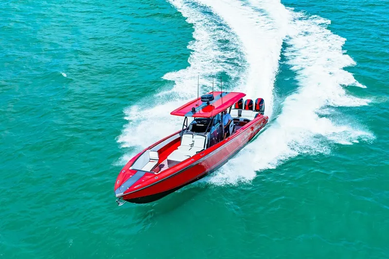  Yacht Photos Pics Red 2022 Nor-Tech 390 SS speedboat cruising on turquoise water.