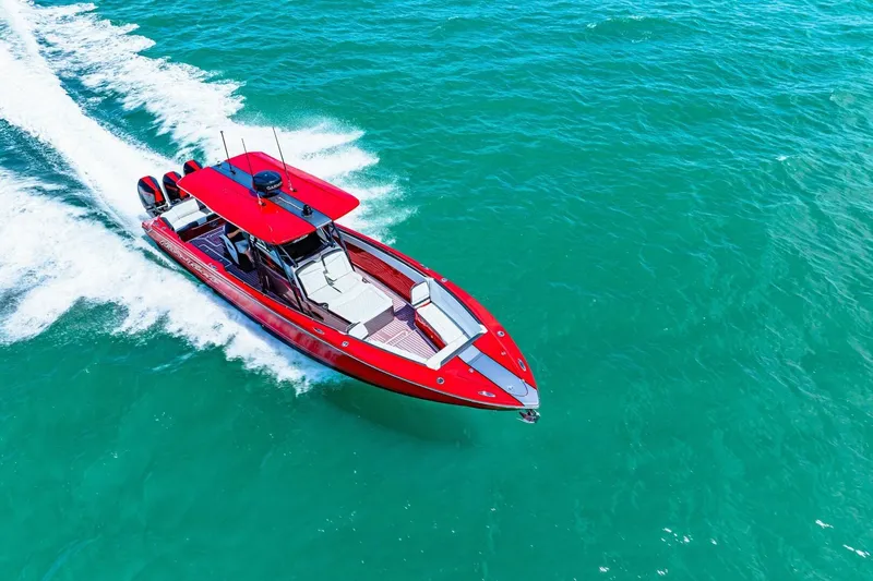  Yacht Photos Pics Red 2022 Nor-Tech 390 SS speedboat cruising on clear blue water.