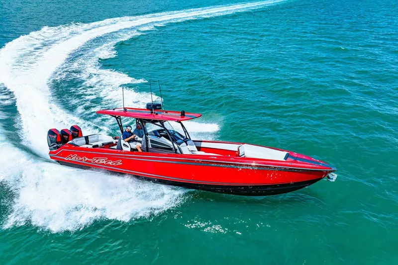  Yacht Photos Pics 2022 Nor-Tech 390 SS speedboat cruising on clear blue water.