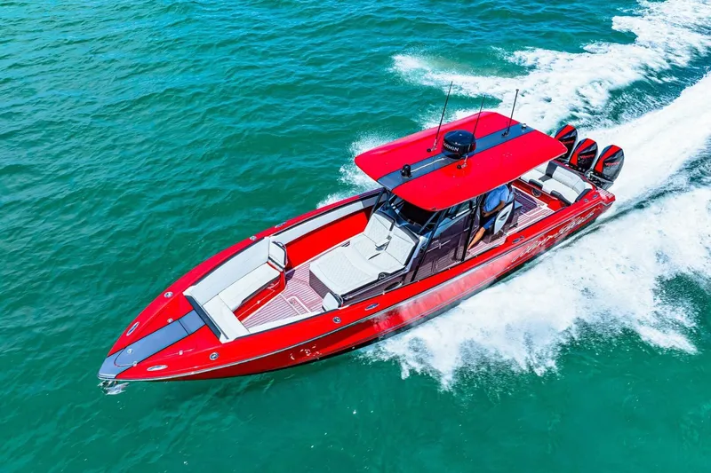  Yacht Photos Pics 2022 Nor-Tech 390 SS boat cruising on clear blue water, showcasing sleek red design.