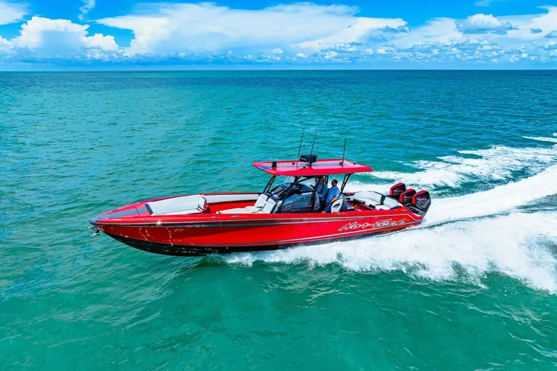  Yacht Photos Pics 2022 Nor-Tech 390 SS speedboat cruising on turquoise ocean under blue sky.