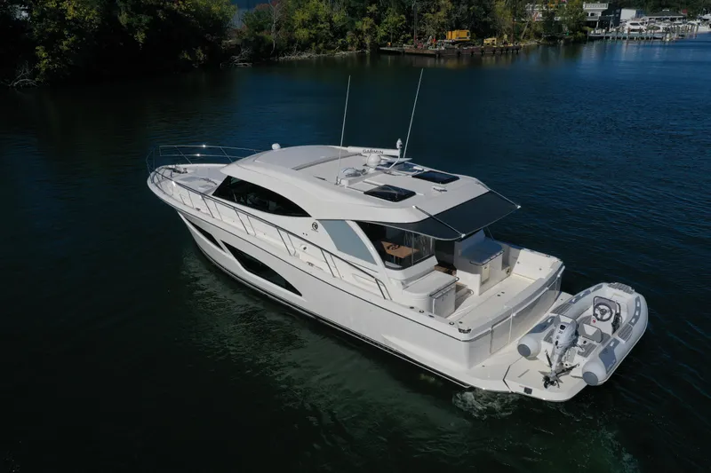  Yacht Photos Pics 2025 Riviera 465 SUV luxury yacht cruising on a serene lake.