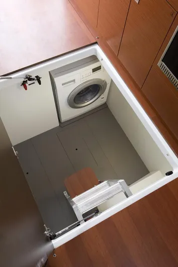 Bee's Knees Yacht Photos Pics Manufacturer Provided Image: Hidden laundry area with washing machine in 2017 Jeanneau NC 14 yacht.