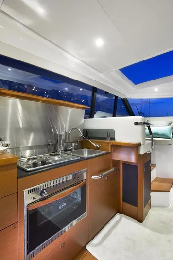 Bee's Knees Yacht Photos Pics Manufacturer Provided Image: 2017 Jeanneau NC 14 yacht kitchen with modern appliances and sleek design.