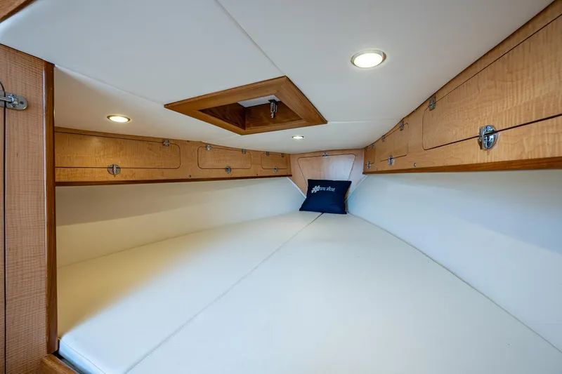 Dreams Afloat Yacht Photos Pics 2019 Custom Carolina Custom Express cabin interior with wood accents and white bedding.