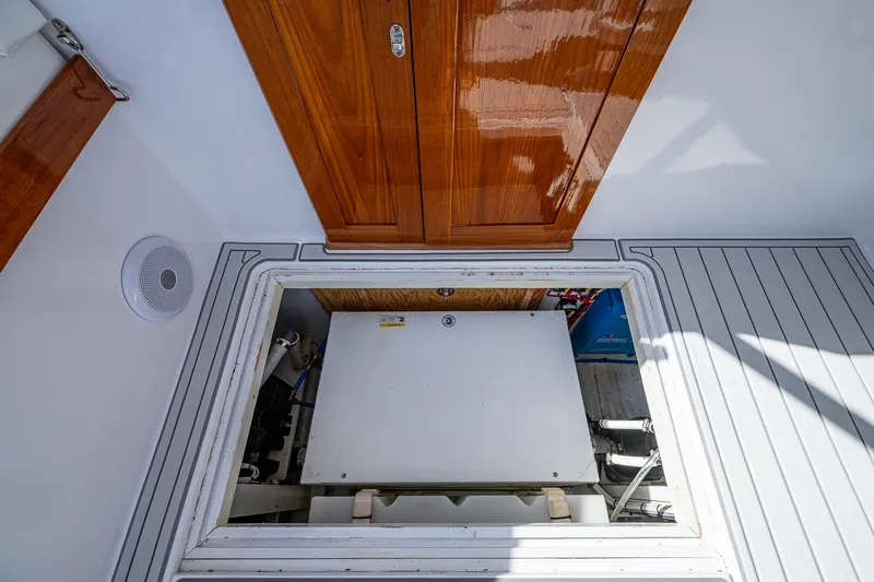 Dreams Afloat Yacht Photos Pics 2019 Custom Carolina Custom Express engine compartment with wooden hatch and sleek interior design.