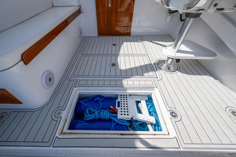 Dreams Afloat Yacht Photos Pics 2019 Custom Carolina Custom Express boat deck with storage compartment open, revealing blue ropes.