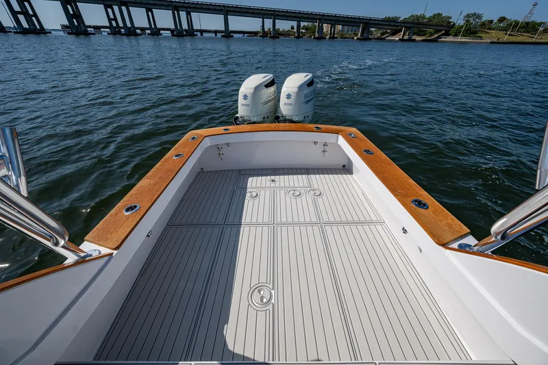 Dreams Afloat Yacht Photos Pics 2019 Custom Carolina Custom Express boat with twin engines on open water near a bridge.