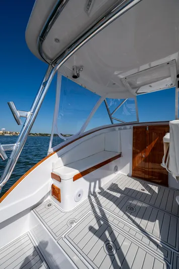 Dreams Afloat Yacht Photos Pics 2019 Custom Carolina Custom Express boat deck with seating, wood accents, and ocean view.
