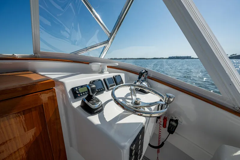 Dreams Afloat Yacht Photos Pics 2019 Custom Carolina Custom Express boat helm with steering wheel and navigation controls.