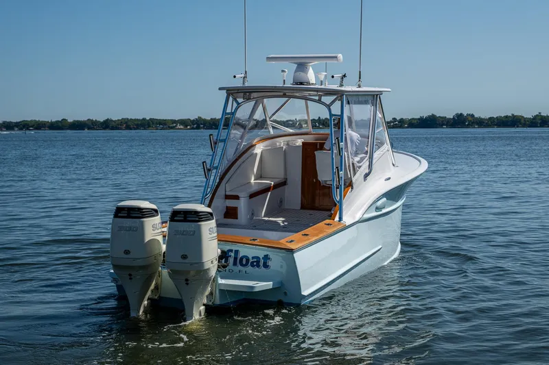 Dreams Afloat Yacht Photos Pics 2019 Custom Carolina Custom Express boat with dual engines on calm water.