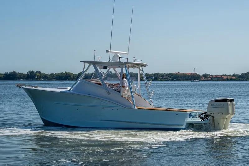 Dreams Afloat Yacht Photos Pics 2019 Custom Carolina Custom Express boat cruising on a calm lake.