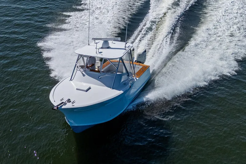 Dreams Afloat Yacht Photos Pics 2019 Custom Carolina Custom Express boat cruising on open water, creating a dynamic wake.