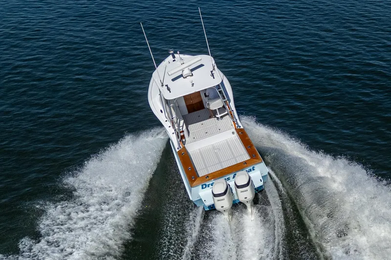 Dreams Afloat Yacht Photos Pics 2019 Custom Carolina Custom Express boat cruising on open water, rear view.