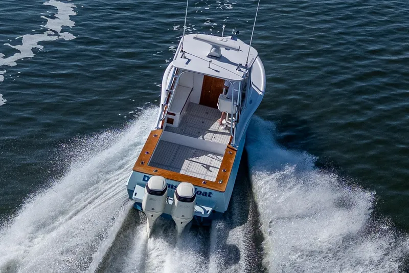 Dreams Afloat Yacht Photos Pics 2019 Custom Carolina Custom Express boat cruising on open water, rear view.