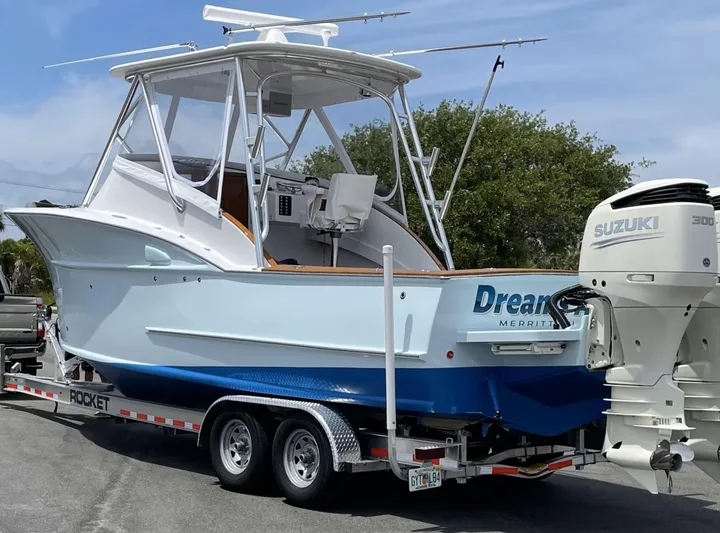 Dreams Afloat Yacht Photos Pics 2019 Custom Carolina Express boat on trailer with Suzuki 300 engine, parked outdoors.