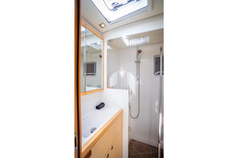 Bluewinds Yacht Photos Pics Bathroom interior of 2023 Lagoon 560 S2 yacht, featuring modern fixtures and natural lighting.