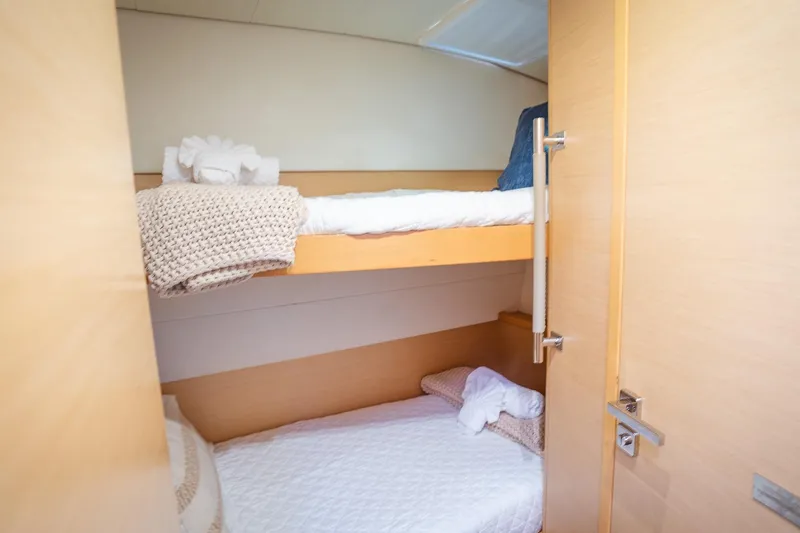 Bluewinds Yacht Photos Pics 2023 Lagoon 560 S2 yacht cabin with cozy bunk beds and soft linens.