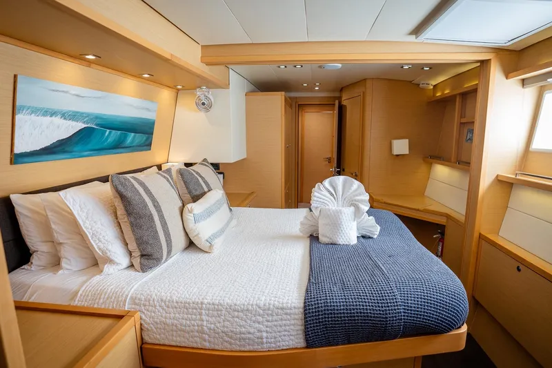 Bluewinds Yacht Photos Pics Luxurious cabin interior of 2023 Lagoon 560 S2 yacht with elegant bedding and decor.