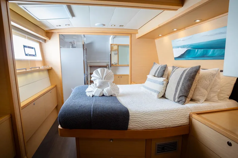 Bluewinds Yacht Photos Pics Luxurious cabin interior of 2023 Lagoon 560 S2 yacht with elegant bedding and decor.