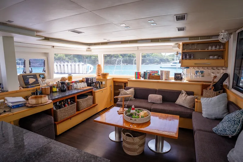 Bluewinds Yacht Photos Pics Luxurious interior of 2023 Lagoon 560 S2 yacht with cozy seating and elegant decor.