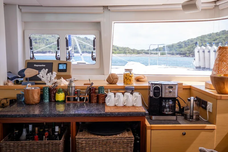 Bluewinds Yacht Photos Pics Interior of 2023 Lagoon 560 S2 yacht with kitchen amenities and ocean view.