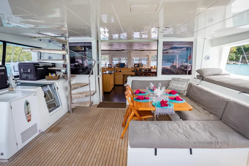 Bluewinds Yacht Photos Pics Luxurious interior of 2023 Lagoon 560 S2 yacht with elegant dining area and modern amenities.