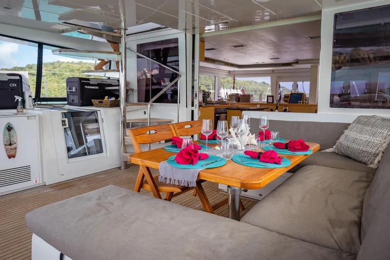 Bluewinds Yacht Photos Pics Luxurious interior of 2023 Lagoon 560 S2 yacht with elegant dining setup.