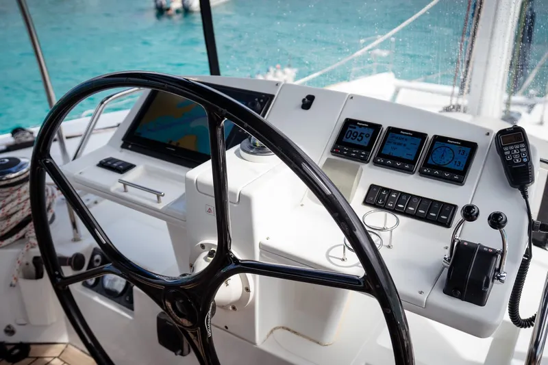 Bluewinds Yacht Photos Pics Helm of 2023 Lagoon 560 S2 yacht with navigation instruments and steering wheel.