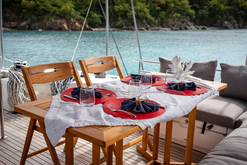 Bluewinds Yacht Photos Pics Elegant dining setup on Lagoon 560 S2 yacht, 2023, with ocean view.