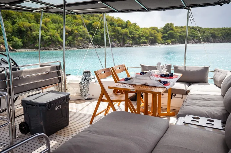 Bluewinds Yacht Photos Pics Luxurious Lagoon 560 S2 yacht interior with seating, table, and ocean view, 2023 model.