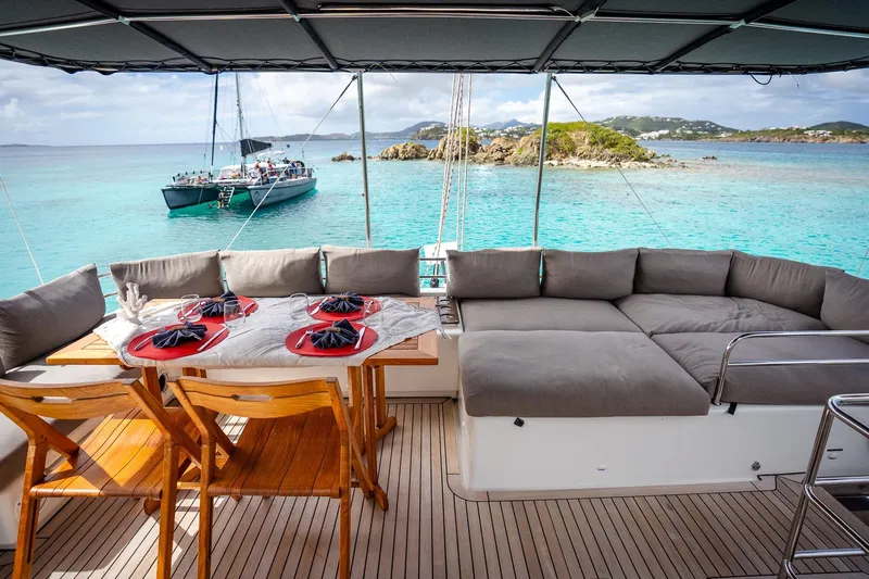 Bluewinds Yacht Photos Pics Luxurious Lagoon 560 S2 yacht interior with dining setup, overlooking turquoise waters, 2023 model.