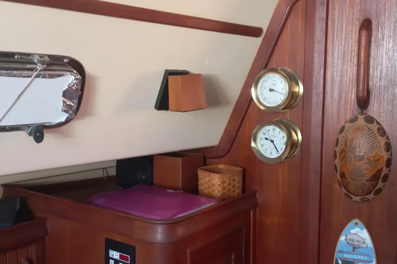 Ivory Star Yacht Photos Pics Interior of 1999 Island Packet 350 sailboat with wooden paneling and nautical instruments.