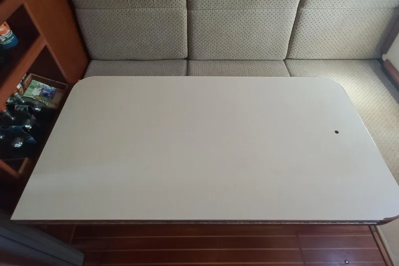 Ivory Star Yacht Photos Pics Interior of 1999 Island Packet 350 sailboat with table and seating area.