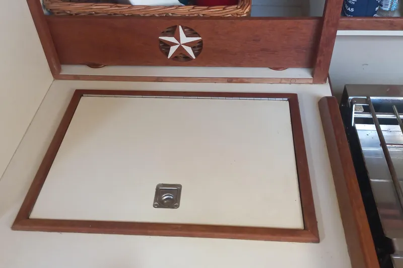 Ivory Star Yacht Photos Pics 1999 Island Packet 350 yacht interior with wooden cabinetry and star design.