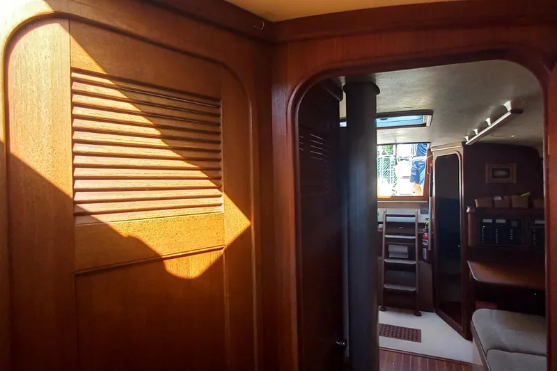 Ivory Star Yacht Photos Pics Interior of a 1999 Island Packet 350 sailboat, featuring wooden cabinetry and natural lighting.