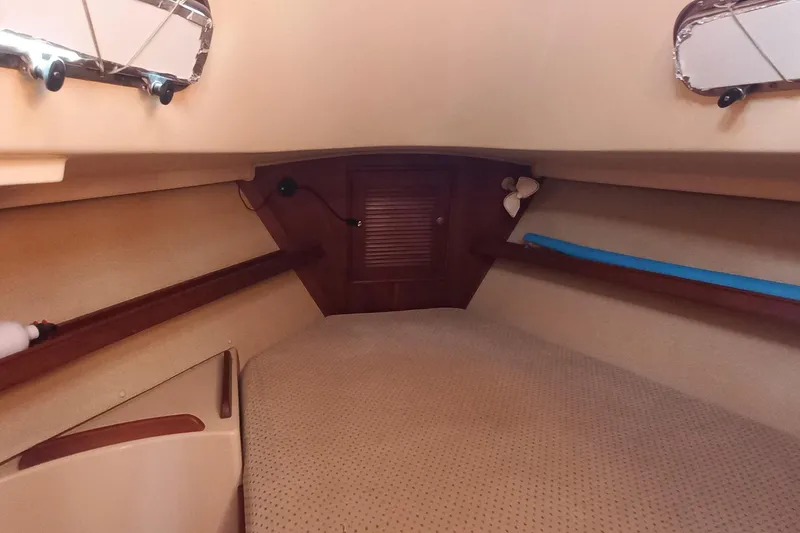 Ivory Star Yacht Photos Pics 1999 Island Packet 350 sailboat interior cabin with cozy bed and wooden accents.