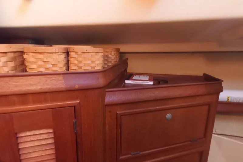 Ivory Star Yacht Photos Pics Interior of 1999 Island Packet 350 sailboat with wooden cabinetry and woven baskets.