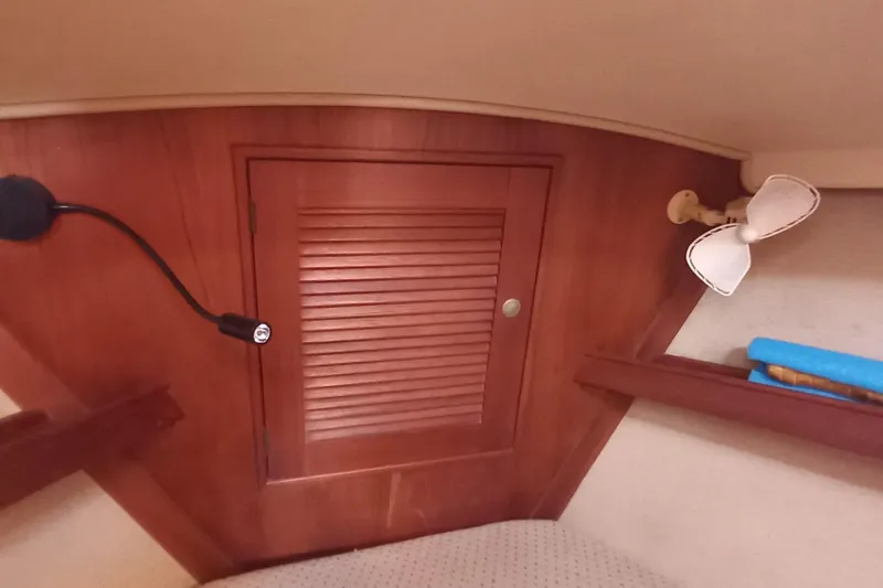 Ivory Star Yacht Photos Pics Interior of 1999 Island Packet 350 sailboat with wooden cabinet and fan.