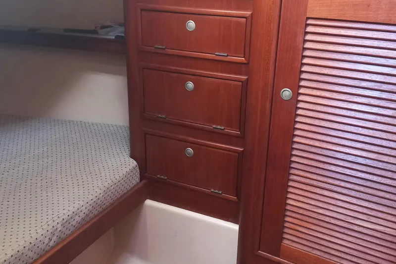 Ivory Star Yacht Photos Pics Interior cabin of 1999 Island Packet 350 sailboat with wooden drawers and bed.
