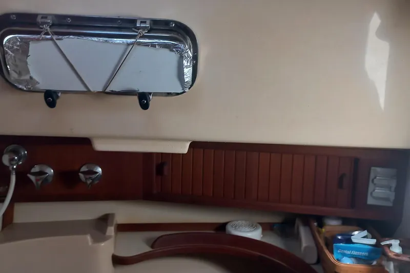 Ivory Star Yacht Photos Pics Interior of 1999 Island Packet 350 sailboat with wooden accents and porthole.