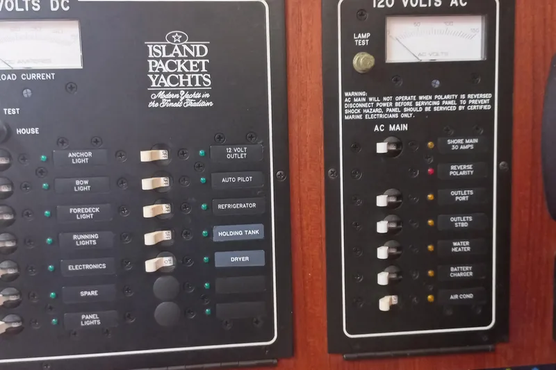 Ivory Star Yacht Photos Pics Electrical control panel of a 1999 Island Packet 350 yacht, featuring various switches and indicators.
