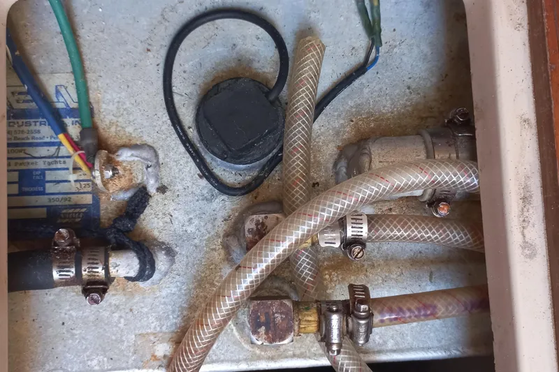 Ivory Star Yacht Photos Pics Engine compartment of a 1999 Island Packet 350 sailboat with hoses and wiring.