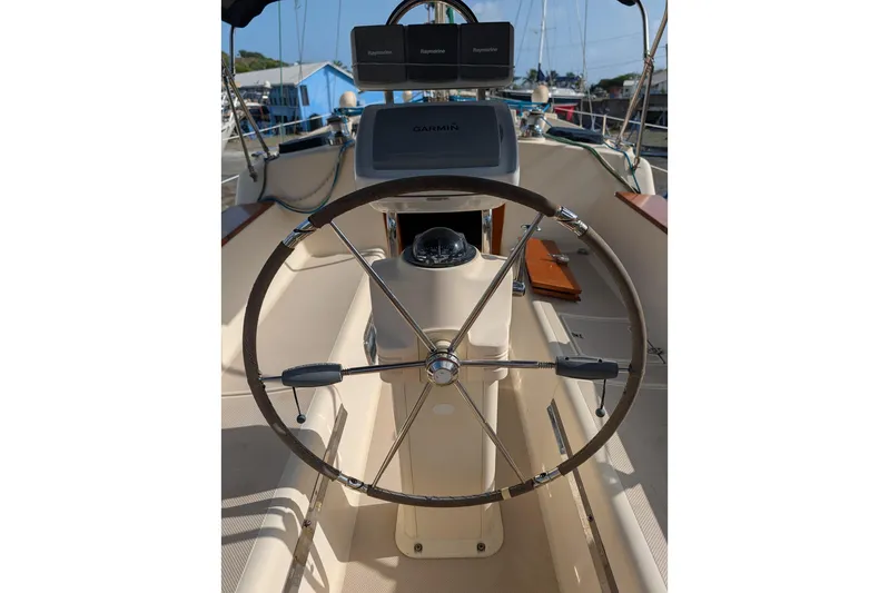 Ivory Star Yacht Photos Pics Cockpit of 1999 Island Packet 350 sailboat with steering wheel and navigation equipment.
