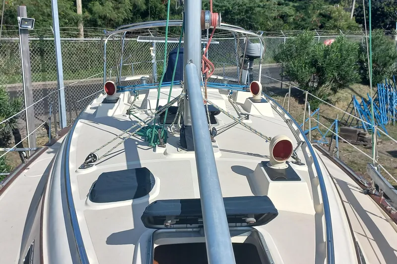 Ivory Star Yacht Photos Pics 1999 Island Packet 350 sailboat deck with rigging and equipment, docked near greenery.