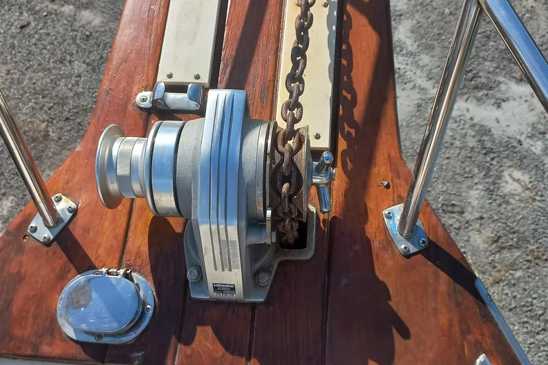 Ivory Star Yacht Photos Pics Anchor windlass on 1999 Island Packet 350 sailboat deck, featuring polished wood and metal fittings.