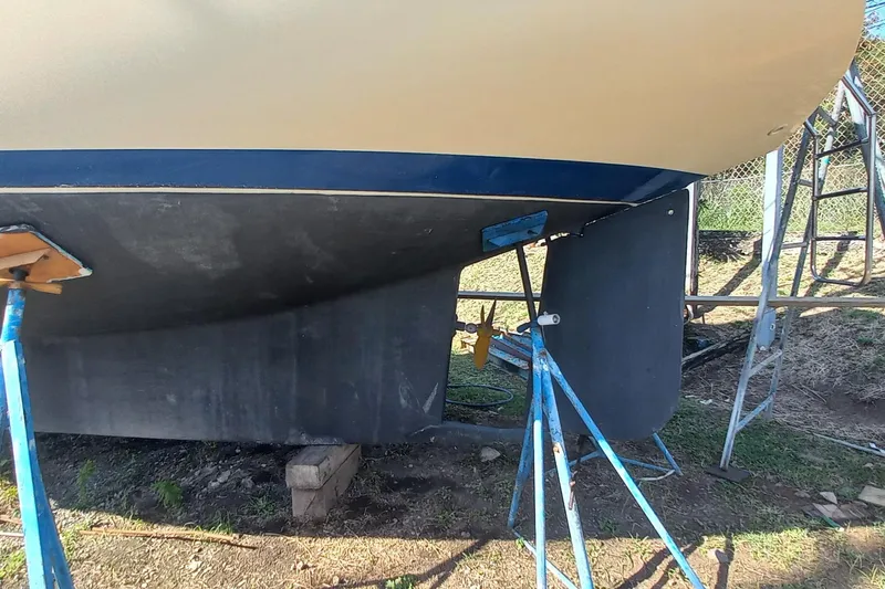 Ivory Star Yacht Photos Pics 1999 Island Packet 350 sailboat hull and rudder on stands, outdoor setting.